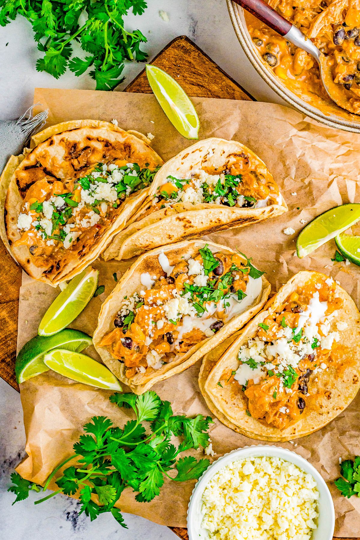 Slow Cooker Fiesta Chicken - An EASY Crock-Pot recipe for fiesta ranch chicken that the whole family LOVES! There's tender chicken, cream cheese, salsa, black beans, green chiles, and more which creates a little fiesta in your mouth! Serve it as-is, over rice, or in tacos. Perfect for busy weeknight dinners or make it for your next game day party! 