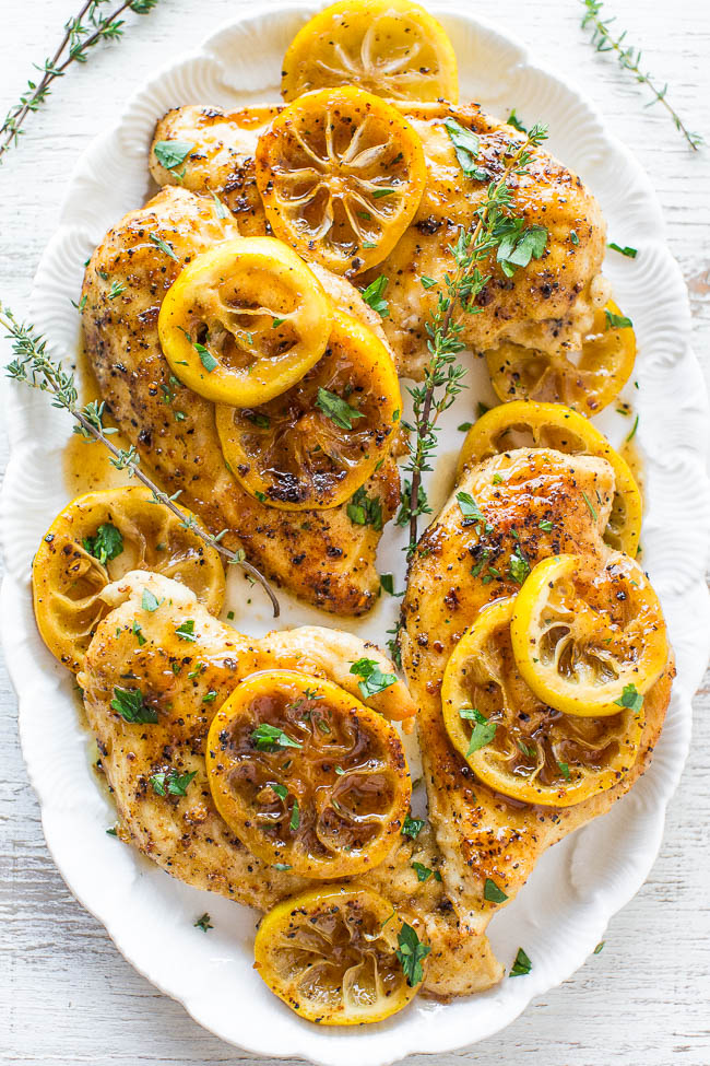 overhead view of four lemon pepper chicken breasts on a white platter 