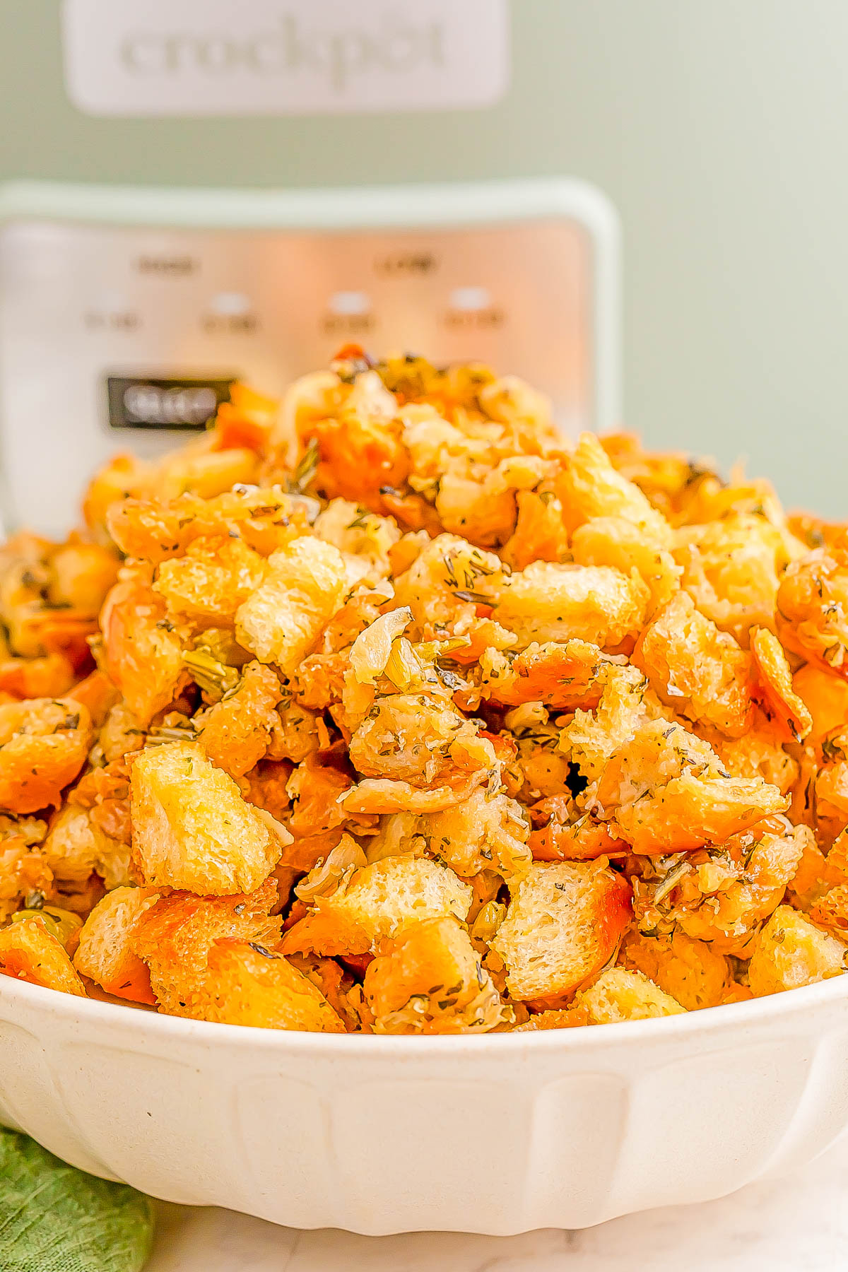 A white bowl filled with seasoned bread croutons.