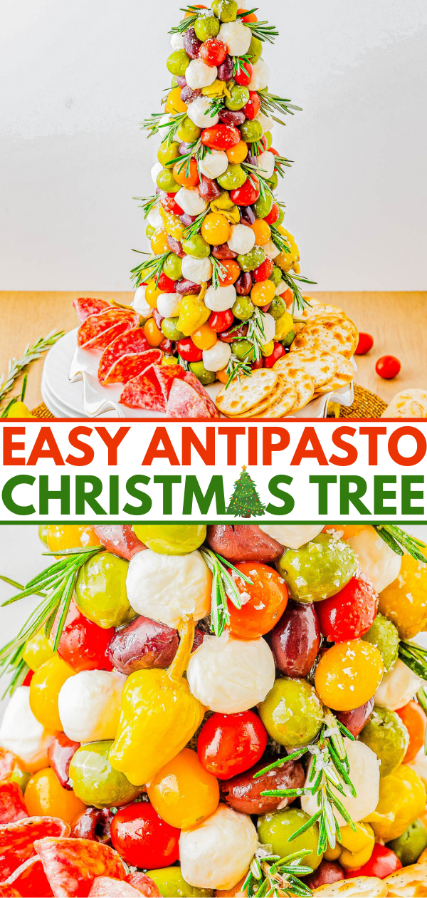 A tower of antipasto items resembling a Christmas tree, featuring tomatoes, mozzarella, olives, and peppers, garnished with rosemary, surrounded by sliced meats and crackers on a platter.