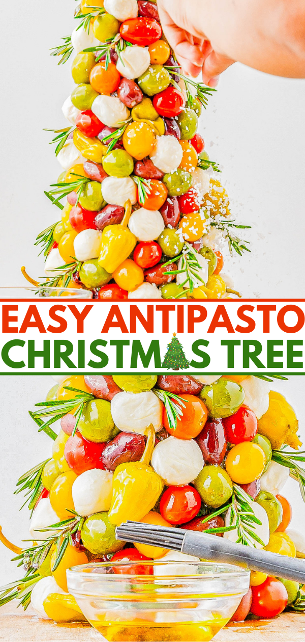 Antipasto Christmas tree with olives, mozzarella, and tomatoes, garnished with rosemary. A hand sprinkles cheese on top, with a small bowl of dressing below.